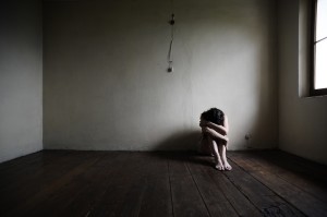sad woman sitting alone in a empty room